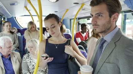Passengers Standing On Busy Commuter Bus - Powered by Adobe