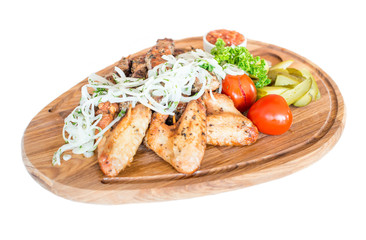 Fototapeta na wymiar Grilled chicken wings with French fries