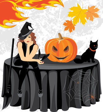 Halloween witch with a bat, cat and pumpkin sitting on the table
