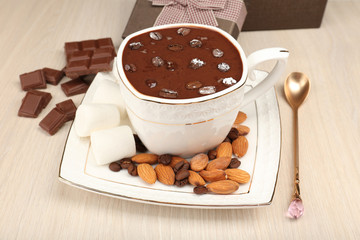 Cup of hot chocolate on table, close up