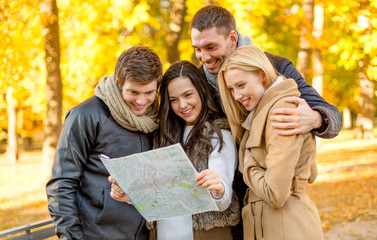 group of friends with map outdoors