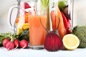 Jar of cut vegetables and glass of fresh carrot juice with