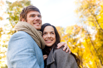 Fototapeta premium smiling couple hugging in autumn park