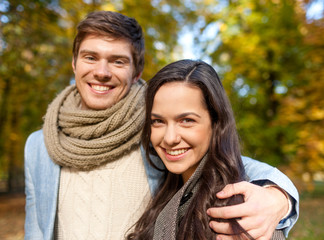 Fototapeta premium smiling couple hugging in autumn park