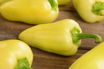 Yellow peppers on wooden background