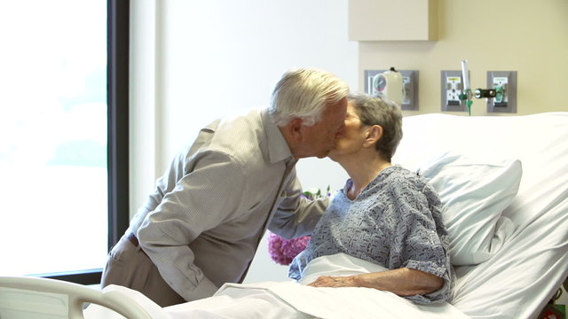 Senior Man Visiting Wife In Hospital Room