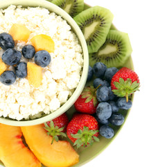 Cottage cheese with fruits and berries in bowl isolated on