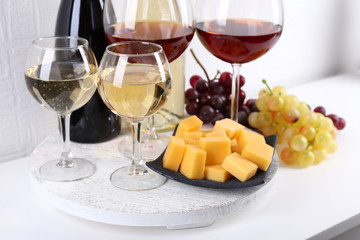 Bottles and glasses of wine, cheese and ripe grapes