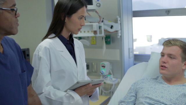 Male Patient Talking To Medical Staff In Emergency Room