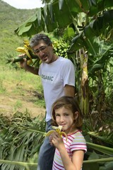 Farmer and daughter in banana plantation