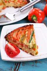 Casserole with vegetables on plate on table close-up