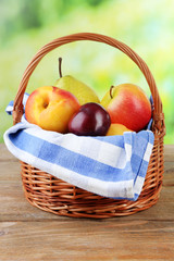 Assortment of juicy fruits in wicker basket