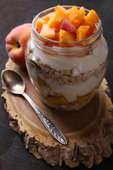 Healthy breakfast - yogurt with  fresh peach and muesli served