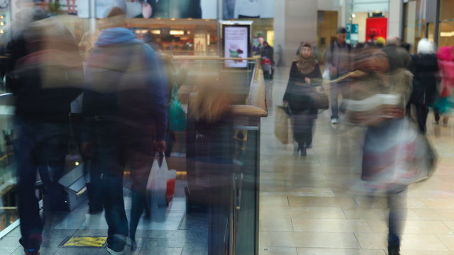 Time Lapse Sequence Of Shoppers On Escalators In Mall