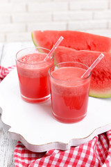 Juicy watermelon on table on brick wall background