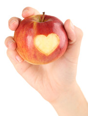 Red apple with heart in hands isolated on white