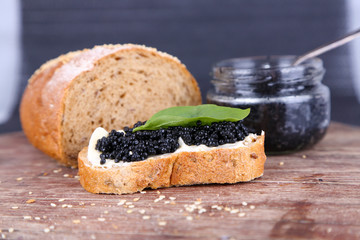 Slices of bread with butter and black caviar