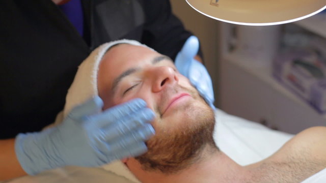 Man Having Dermo Abrasion Cosmetic Treatment At Spa