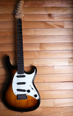 Fototapeta na wymiar Guitar on wooden background