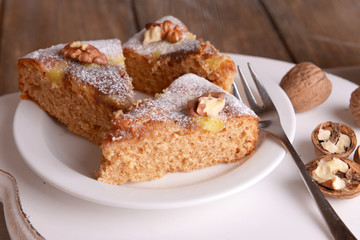 Pieces of delicious cake with nuts