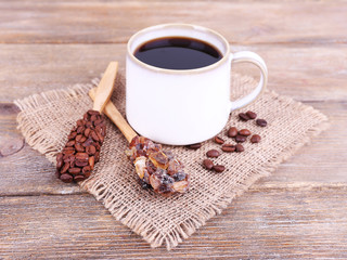 Obraz na płótnie Canvas Mug of coffee on sackcloth on wooden background