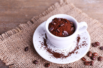 Mug of coffee beans and ground coffee