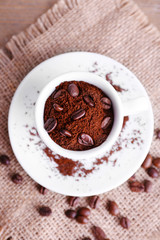 Mug of coffee beans and ground coffee