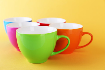 Colorful cups on color background