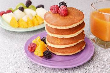 Pancake with fruits and berries on plate on table close up