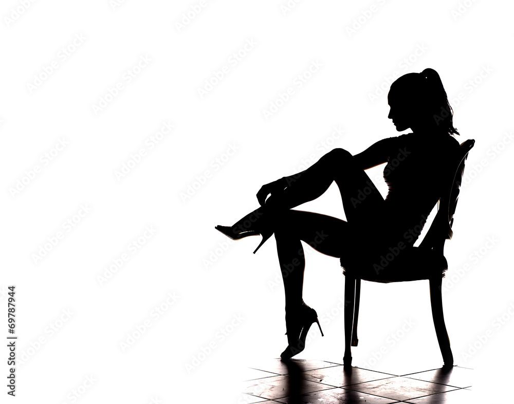 Wall mural silhouette of pretty stripper on a chair