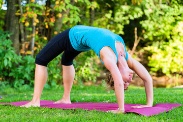 Young woman in nature doing yoga