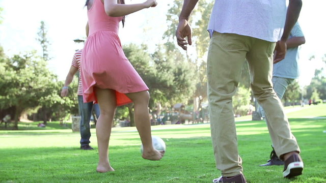 Slow Motion Sequence Of Friends Playing Soccer In Park