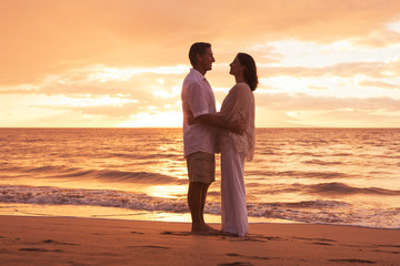 Mature Couple Enjoying Sunset on the Beach