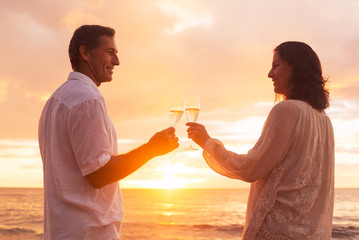 Couple Enjoying Glass of Champene on the Beach at Sunset