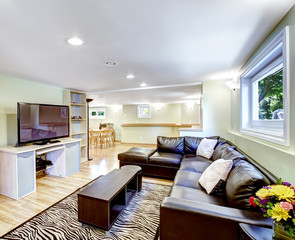 Mother-in-law apartment interior. Living room with black leather