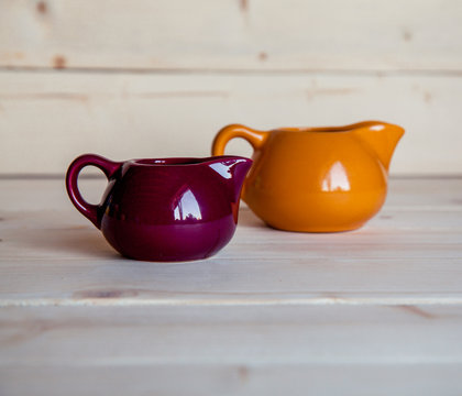 orange and maroon dishes for cream