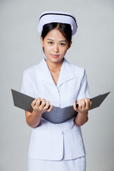 Young Asian nurse with a folder