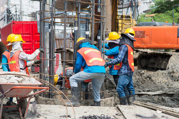 Construction workers working in site bridge piling