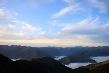 View to the mountains chain with clouds in between peaks and nic