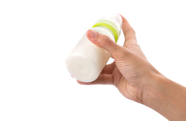 Female hand holding a baby bottle of milk 