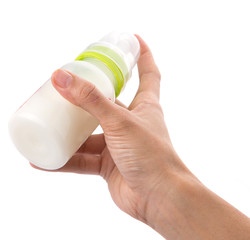 Female hand holding a baby bottle of milk 