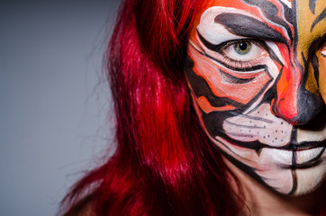 Woman with tiger face in halloween concept