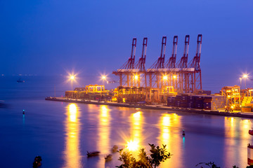 Fototapeta na wymiar Port warehouse with cargoes and containers at night