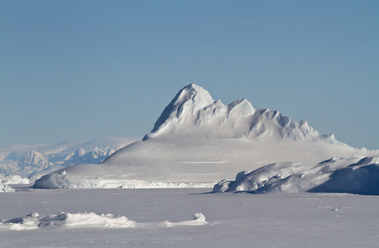 Pyramid prominent iceberg frozen in winter Antarctic waters