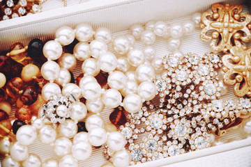 Pearls and vintage jewelry pieces in jewelry box