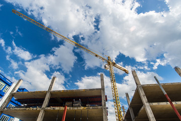 Naklejka premium Construction site with cranes on blue sky background