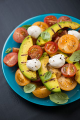 Vegetable salad with grilled avocado, close-up, vertical shot