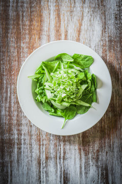 Salas with spinach,cucumber and microgreens on wooden background