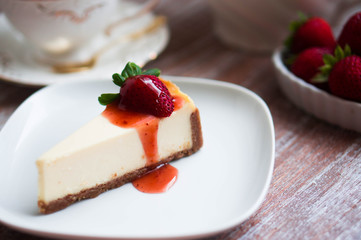 Strawwberry cheesecake on rustic background