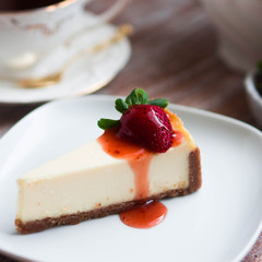 Strawwberry cheesecake on rustic background